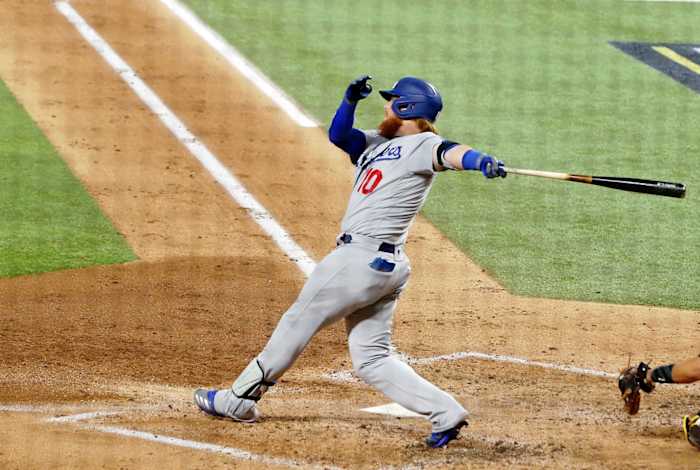 Oct 8, 2020; Arlington, Texas, USA; Los Angeles Dodgers third baseman Justin Turner (10) hits an RBI single against the San Diego Padres during the third inning during game three of the 2020 NLDS at Globe Life Field. Mandatory Credit: Kevin Jairaj-USA TODAY Sports